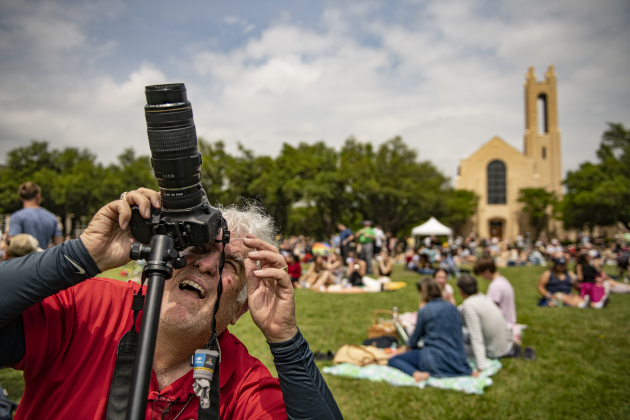 Robby Denton, with a solar filter on his camera to protect his eyes, traveled from Houston for the eclipse.