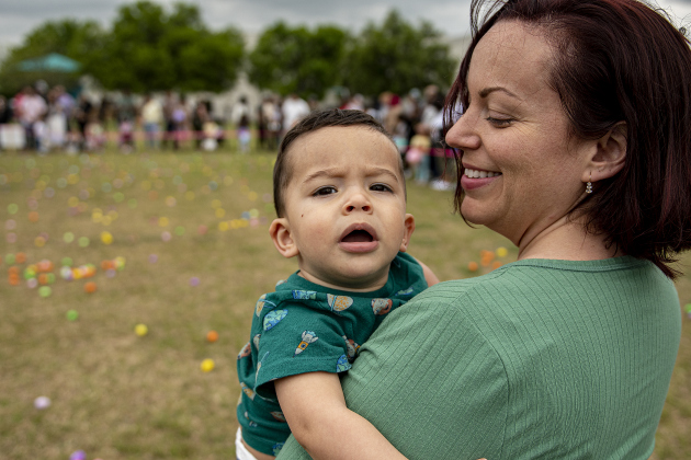 Ezekiel Molina, whose first birthday is on Easter Sunday, waits with his mom Melody Molina to gather Easter eggs for the first time during the annual Easter egg hunt at Georgetown Church of the Nazarene on Saturday, March 30, 2024.