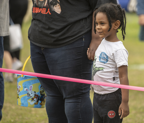 3-year-old Zavion Collins waits with his mom Denise Harris to gather Easter eggs during the annual Easter egg hunt at Georgetown Church of the Nazarene on Saturday, March 30, 2024.