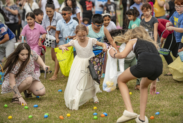8-year-old Olivia Morrow was well-attired in her white dress as she joined others to gather Easter eggs during the annual Easter egg hunt at Georgetown Church of the Nazarene on Saturday, March 30, 2024.