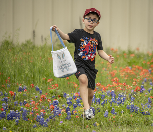 5-year-old Hudson Dimitri enjoyed strolling through the wildflowers after gathering his eggs during the annual Easter egg hunt at Georgetown Church of the Nazarene on Saturday, March 30, 2024.