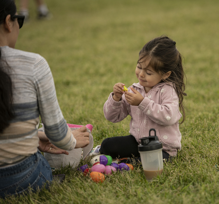 Mom Laura Alcaraz, left, enjoyed looking at gathered treats with her daughter Valentina Moreno, 2, during the City of Taylor's Easter Egg Hunt held Saturday, March 30, 2024 at Taylor's Memorial Stadium on Davis Street.