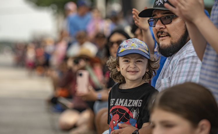 2-year-old Elliott Araiza, with his dad Bert Araiza, enjoyed watching the parade along Austin Avenue during the 25th Annual Red Poppy Festival on Saturday, April 27, 2024.    Photo by Andy Sharp. 