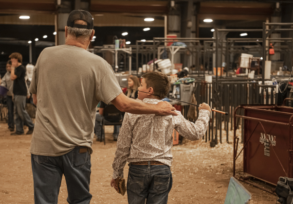 Coy Roberson, 10, a member of the Liberty Hill 4-H Club, won the Junior Showmanship award n the Breeding Swine show. He spends time with his grandfather, Brian Roberson.