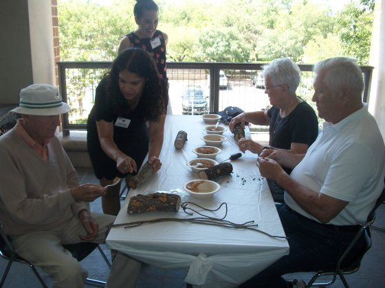 Volunteers and staff from A Gift of Time help Camille’s Memory Café participants build bird feeders May 19 on a deck outside Georgetown Public Library.