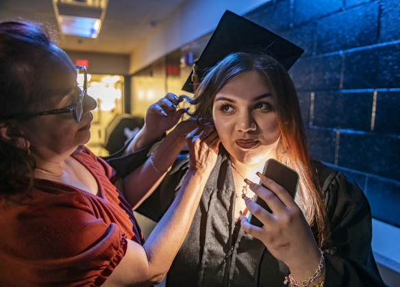 Mary Castaneda helps her granddaughter Juliana Orlando, 17, get ready to go onstage for the 2024 Richarte High School Commencement held at the Rodney and Mary Klett Performing Art Center on Thursday, May 23, 2024. 62 seniors received their diploma tonight, with the total expected to reach 77 total graduates by the end of summer.    Photo by Andy Sharp. 