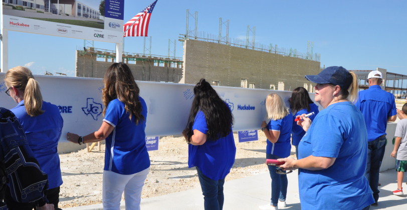 Community members line up to sign a steel beam that will be used in the construction of Jarrell Ranch Middle School during the June 6 ceremony.  Photos by Nicholas Cicale