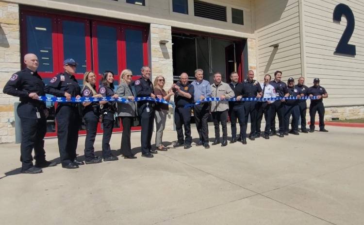 County Commissioner Cynthia Long, center, and Liberty Hill Fire Chief Anthony Lincoln cut the ribbon to open the new county EMS station. Photos by Nalani Nuylan.