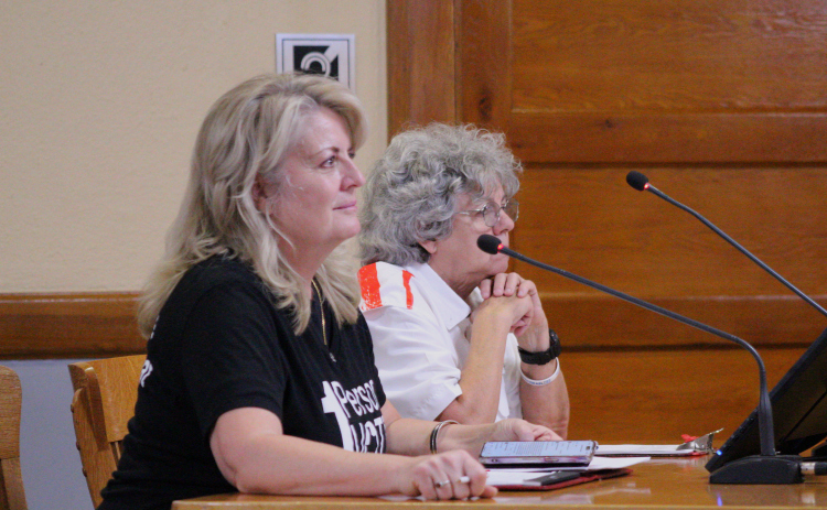 Marcia Waston from Citizens Defending Freedom, left, joined by resident Cathy Jaster speaks to Item 24 regarding the Secretary of State Advisory during the July 2 Commissioners Court meeting. Photo by Nalani Nuylan.